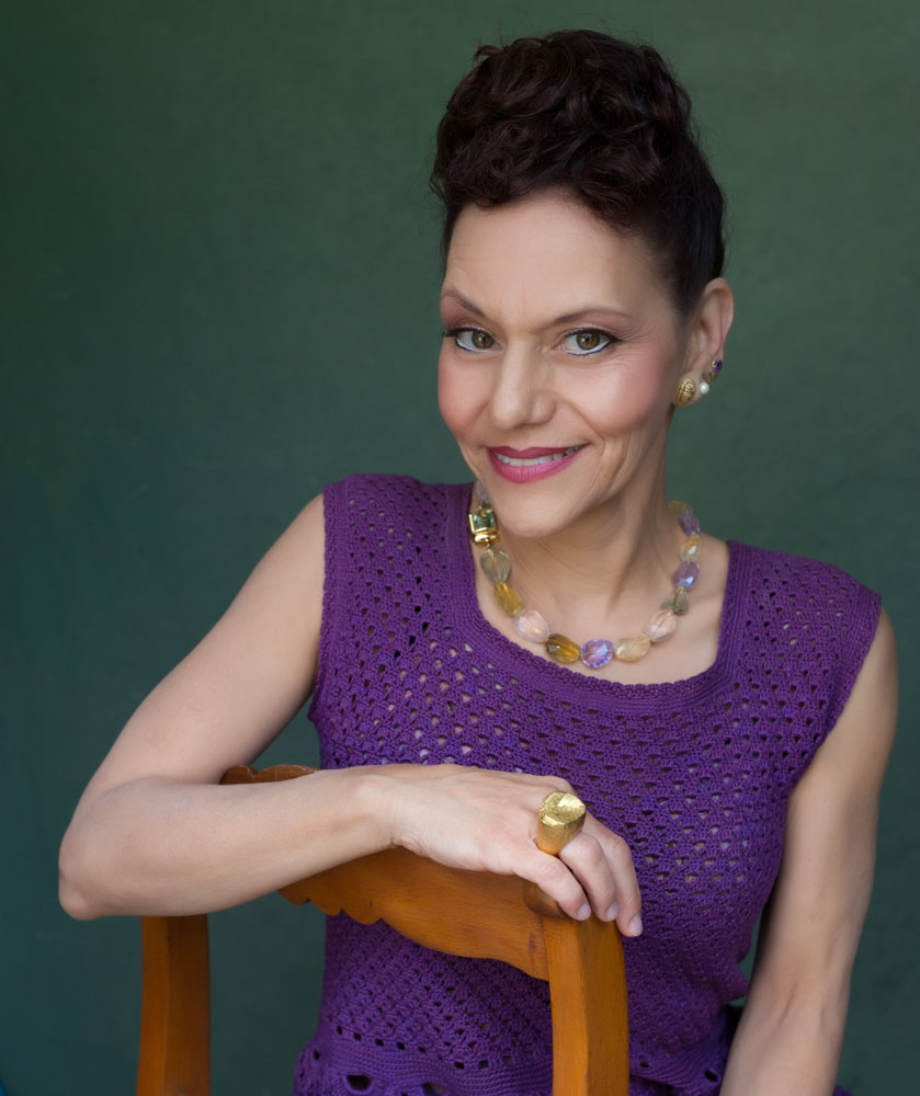 Traci, A Living Beauty wearing necklace and gold ring