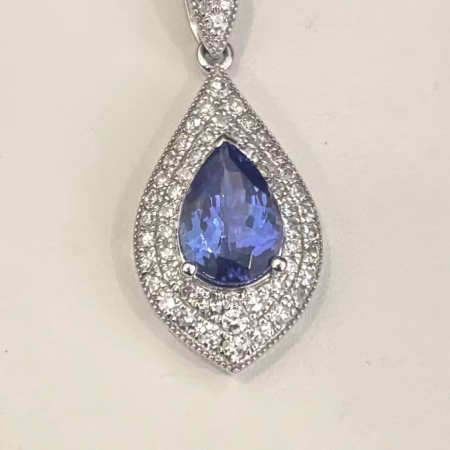 14K white gold pear shaped tanzanite pendant with diamond halo.